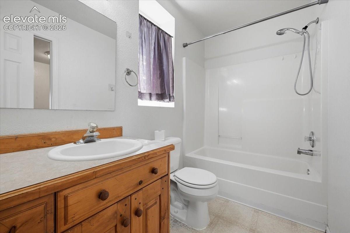 Wood-finish vanity with an integrated sink and mirror