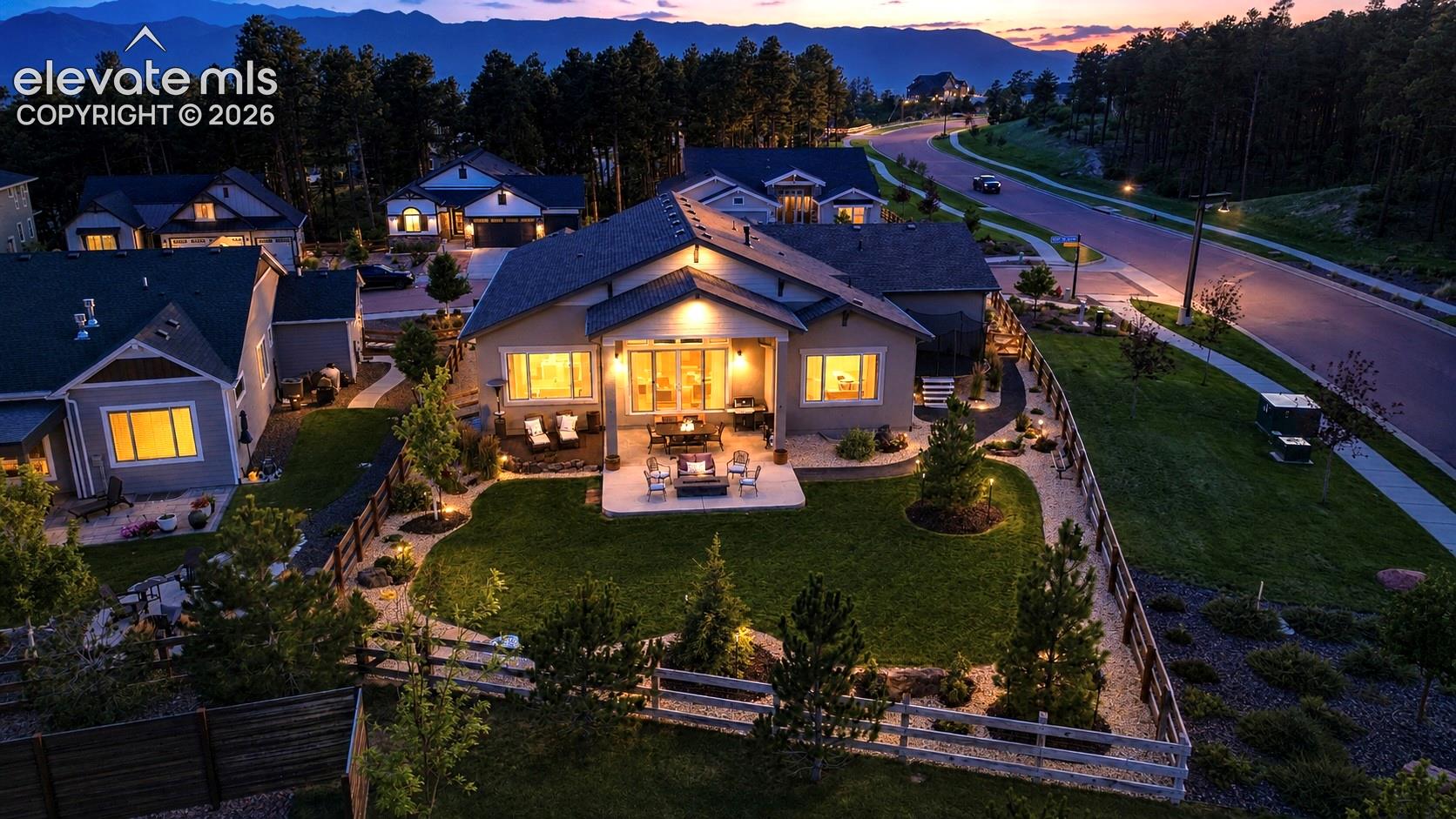 DRAMATIC SETTING, TIMELESS BEAUTY — Commanding a striking corner-lot position and nestled alongside towering pines, this exceptional home enjoys a setting that feels both grand and beautifully connected to nature.