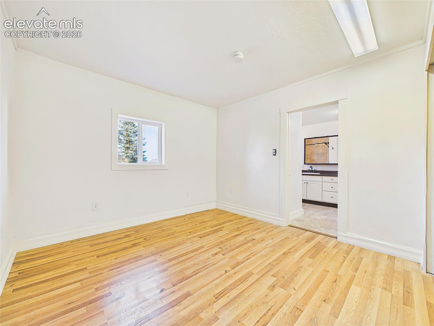 Primary Bedroom – Generously sized primary suite offers flexible furniture placement, large windows, and a peaceful retreat with an attached bath.