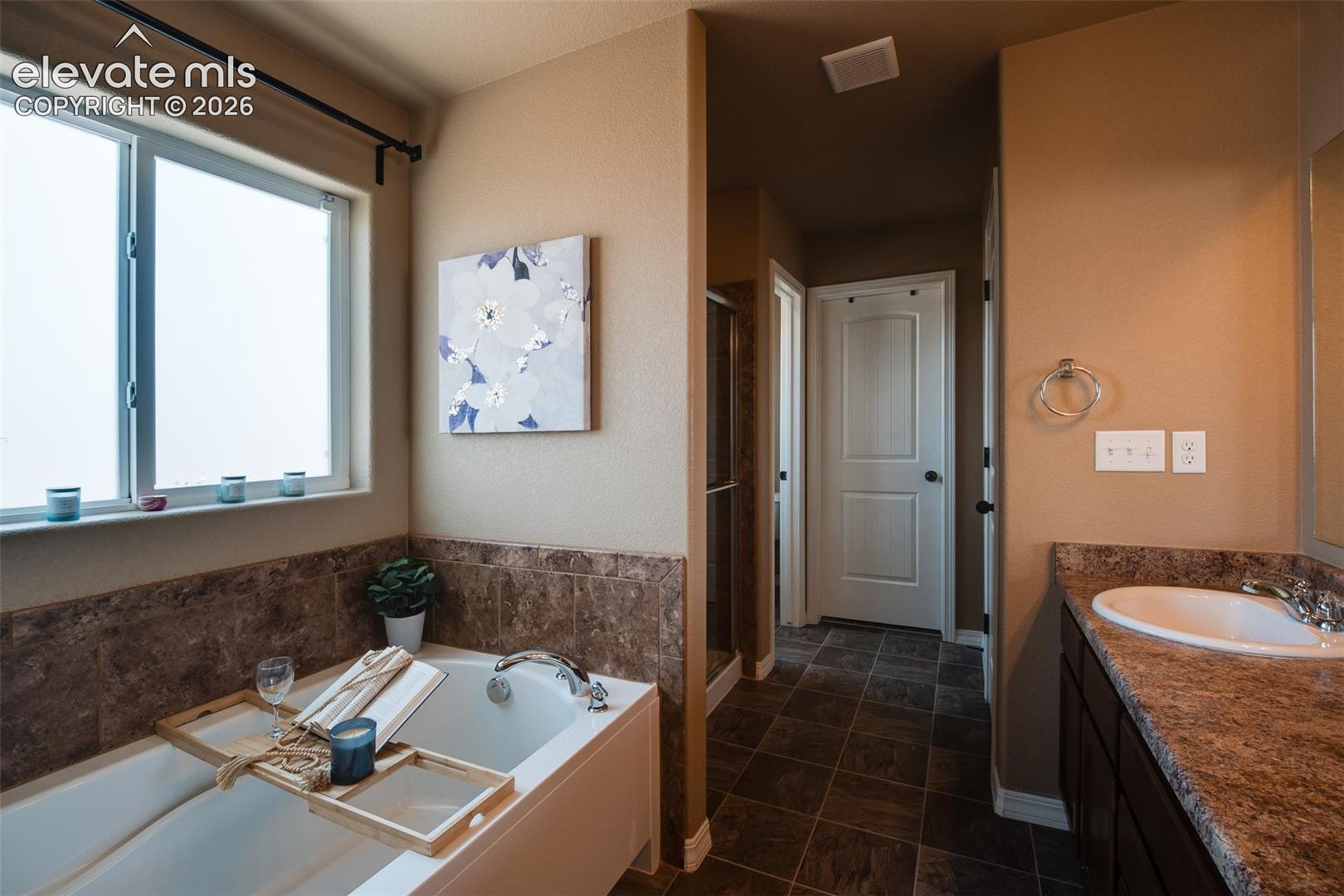 View into the Primary Bedroom from the Primary Bathroom.