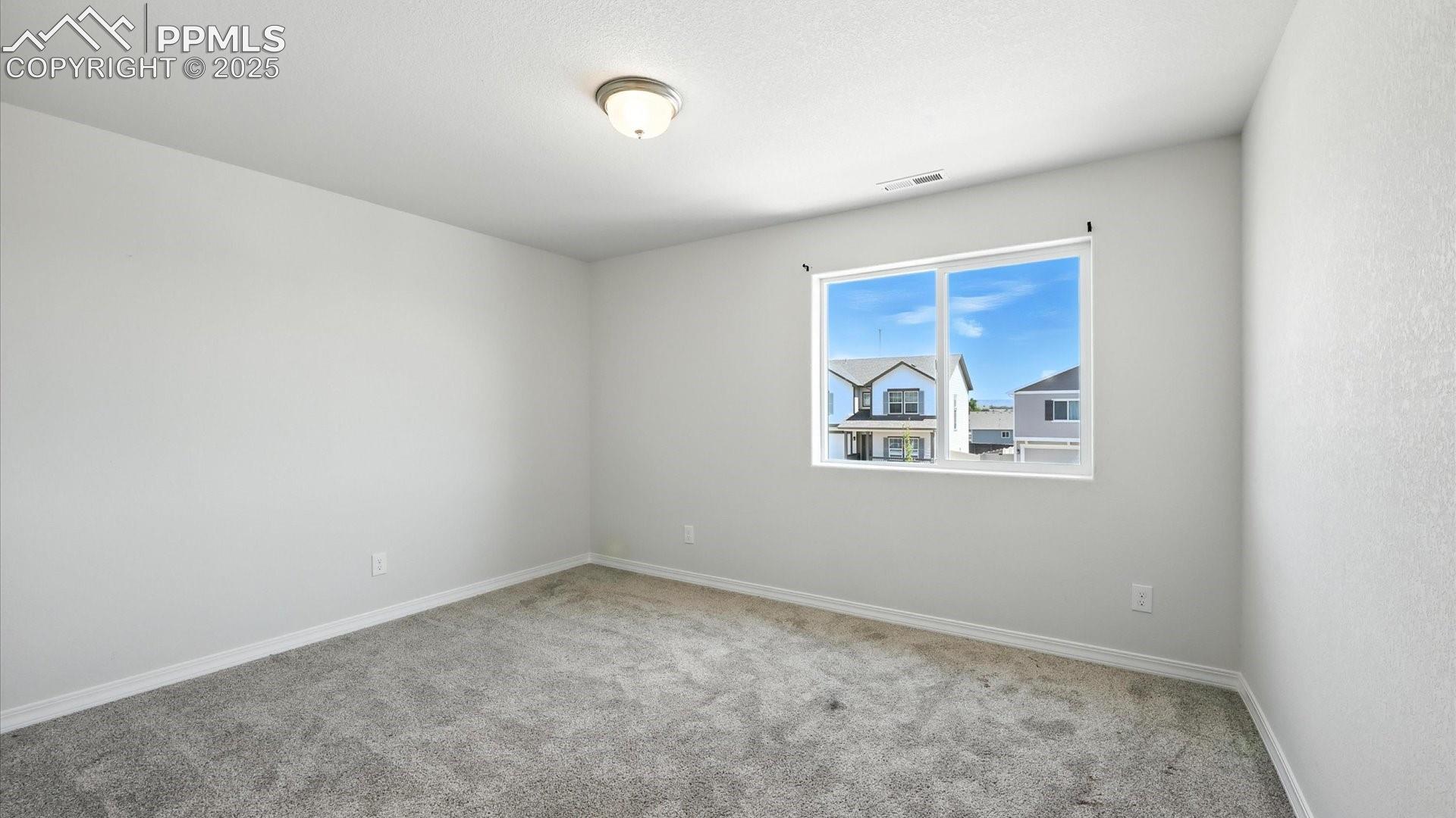 Upper Level Bedroom #2 with neutral carpet.