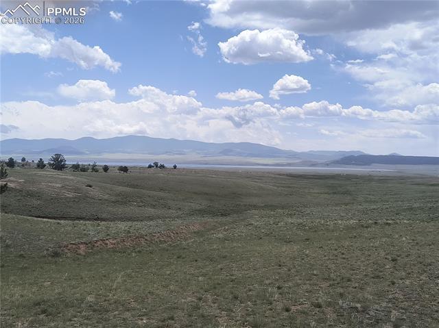 View of mountain backdrop with rural landscape