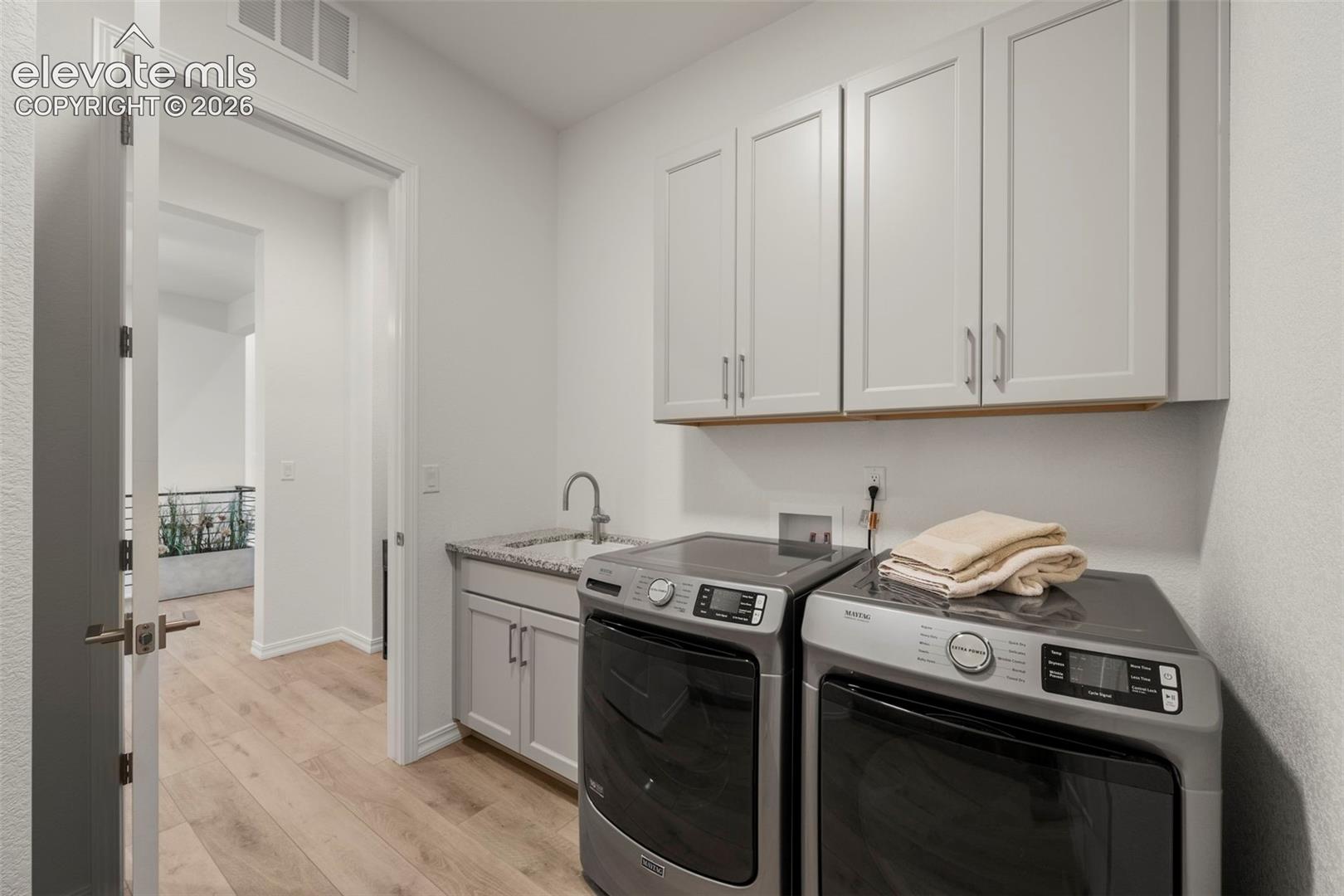 Main level laundry attached to primary bedrooms walk-in closet.  For added convenience there is a lower level laundry room as well
