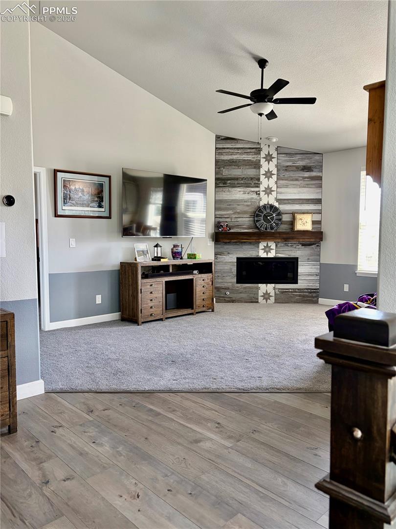 Living room with fireplace, vaulted ceilings and two tone paint