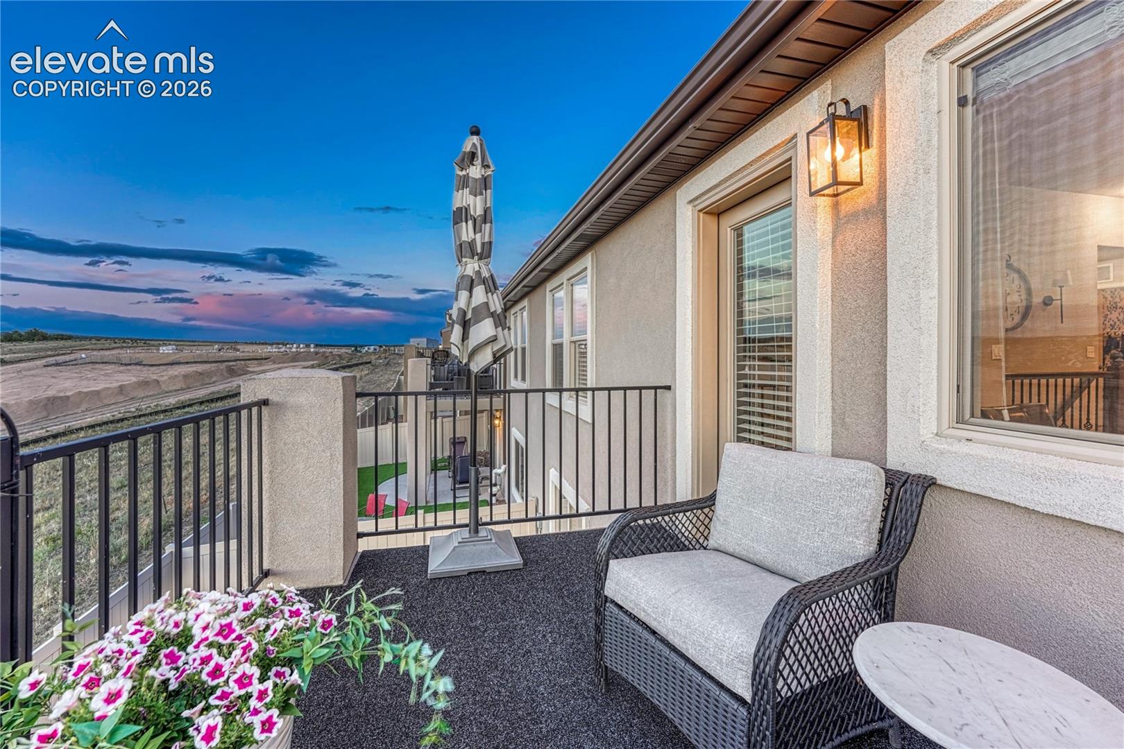 The upper-level balcony provides a peaceful place to enjoy fresh air, morning coffee, or scenic views throughout the day.