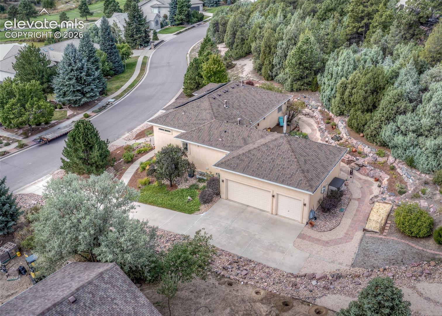 The oversized 3-car garage features a workshop and tall ceilings.