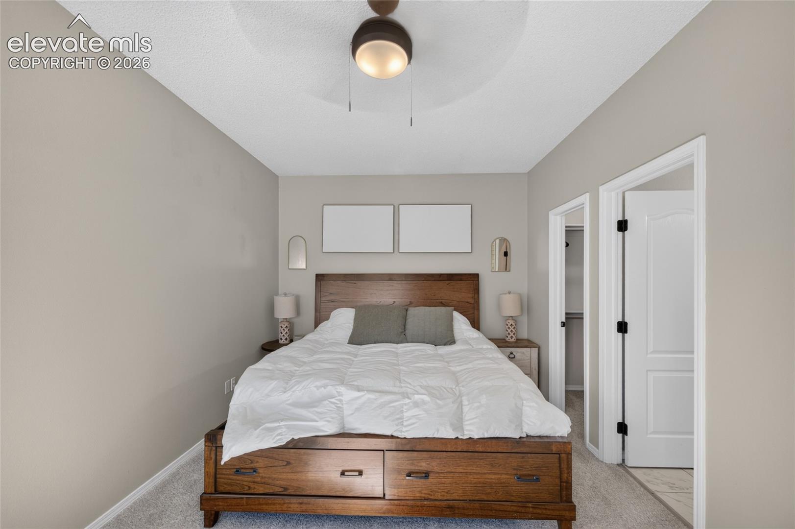 Primary suite with walk-in closet and attached bath
