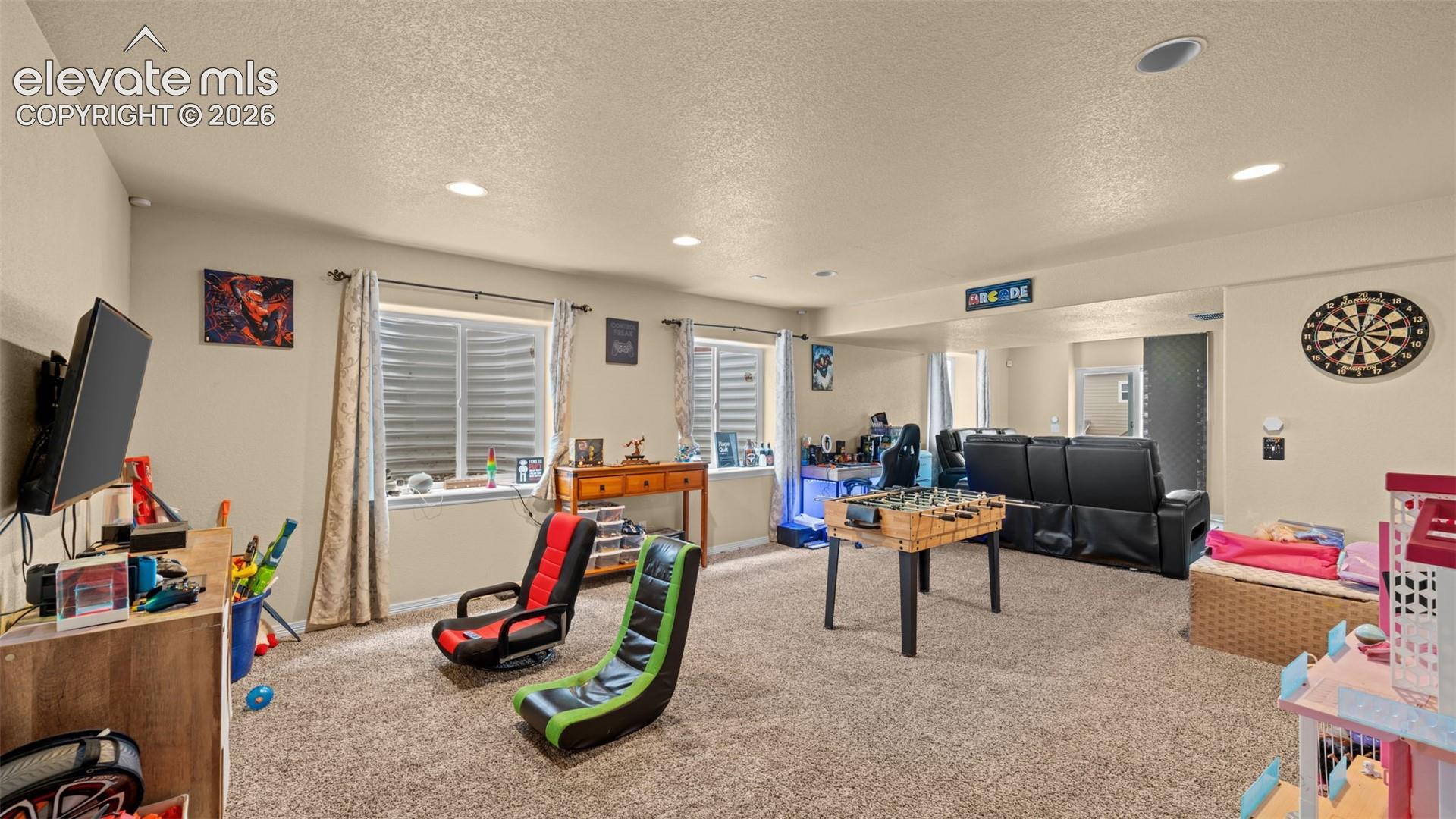 Spacious room featuring neutral paint, recessed lighting