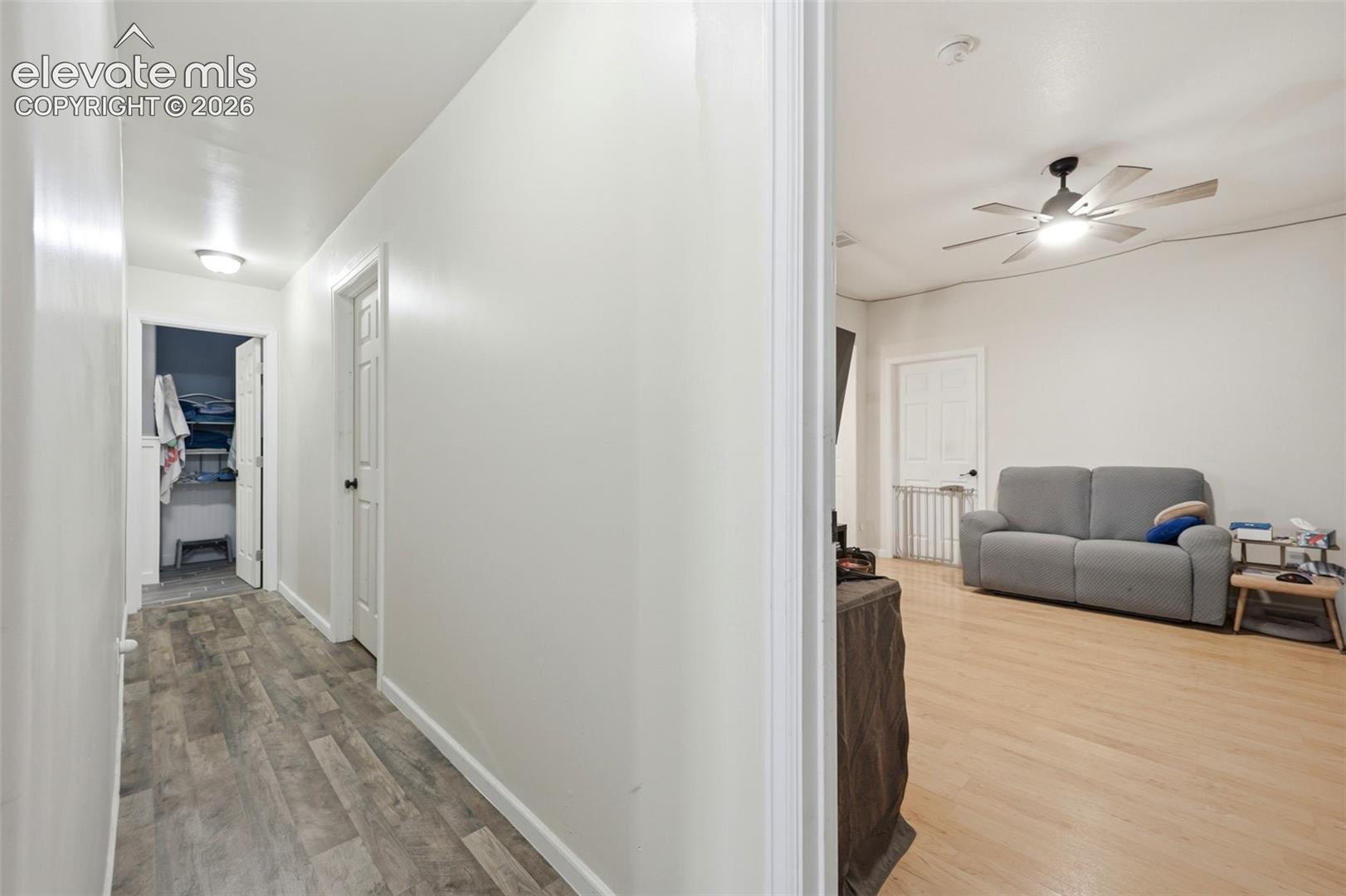 Interior hallway featuring wood-finish flooring and flush-mount lighting