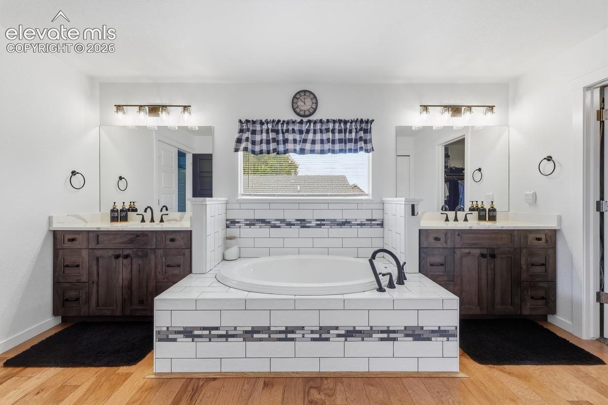 a large soaking tub is the centerpiece of this bathroom
