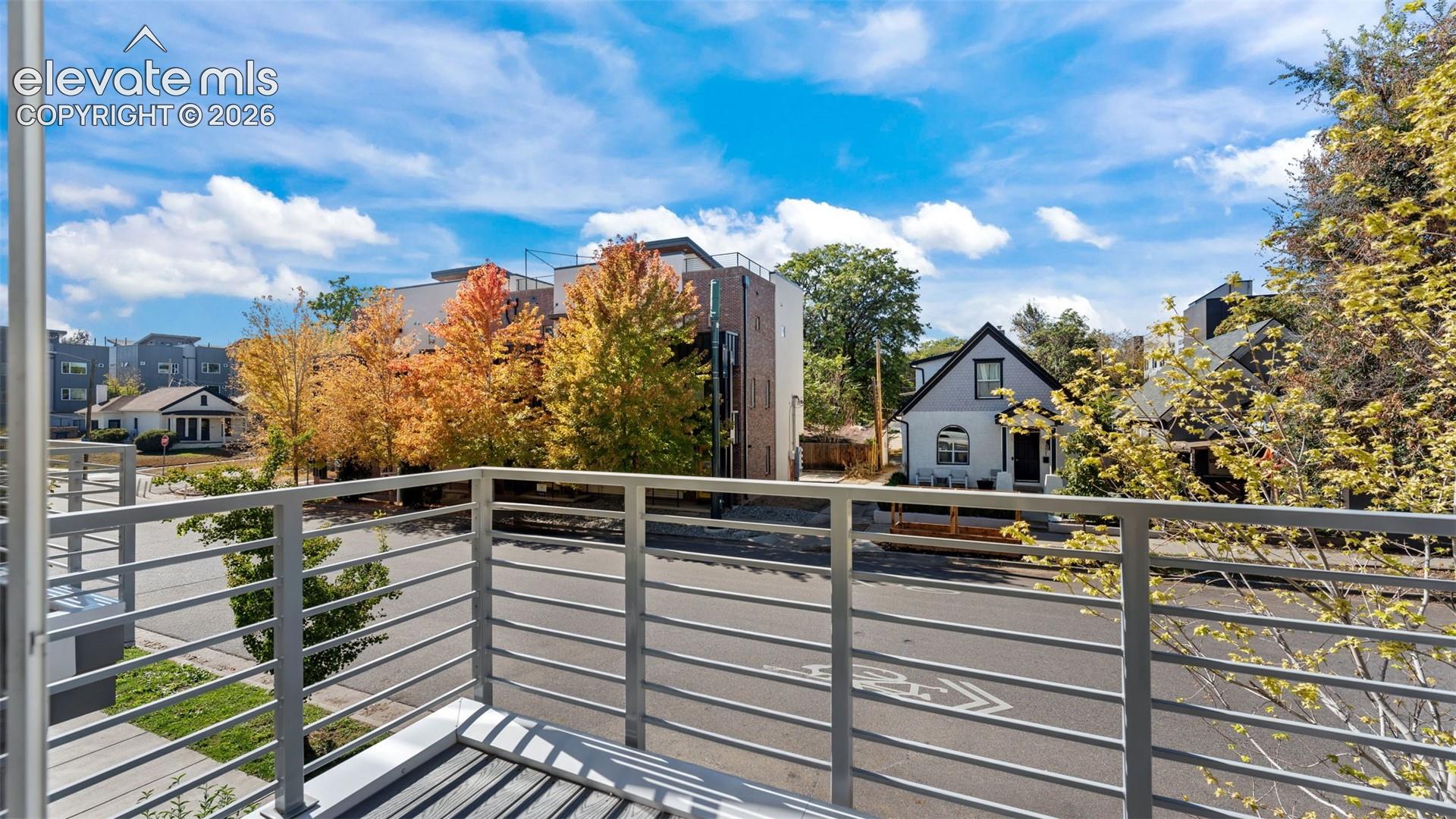 Balcony featuring metal railings and horizontal decking