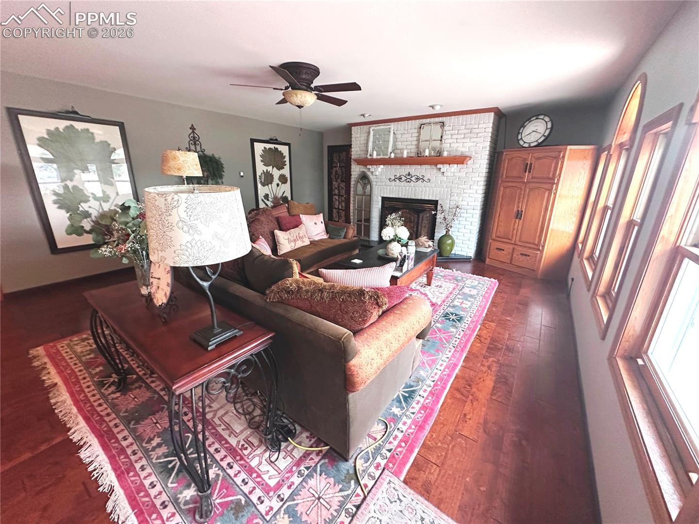 Living room seating area with fireplace at top.  Door to great room and 4th bedroom to left of fireplace.