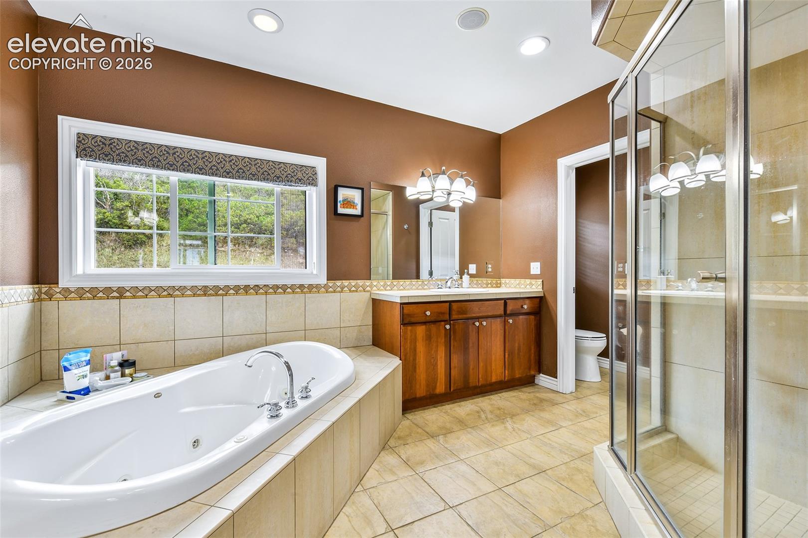 5 piece primary bath with double vanity, walk-in shower, jetted tub and mountain views