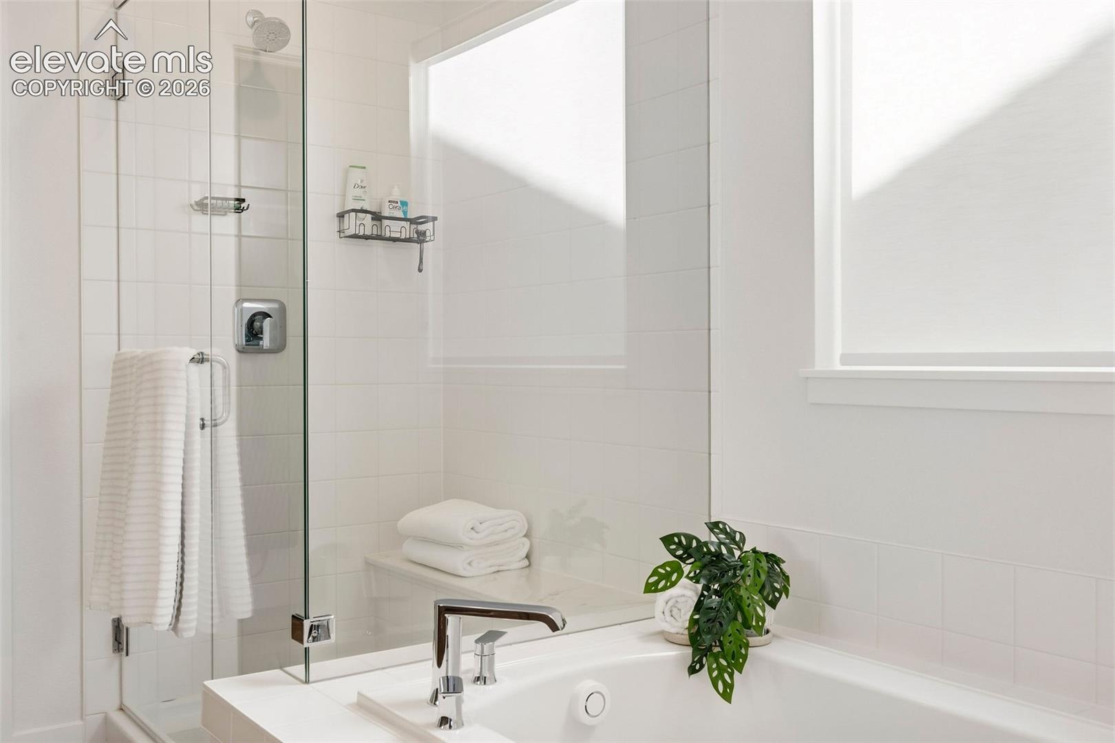 Enjoy a luxurious bath in the oversized soaking tub, or a long, hot shower in the glass-enclosed shower with seating. 