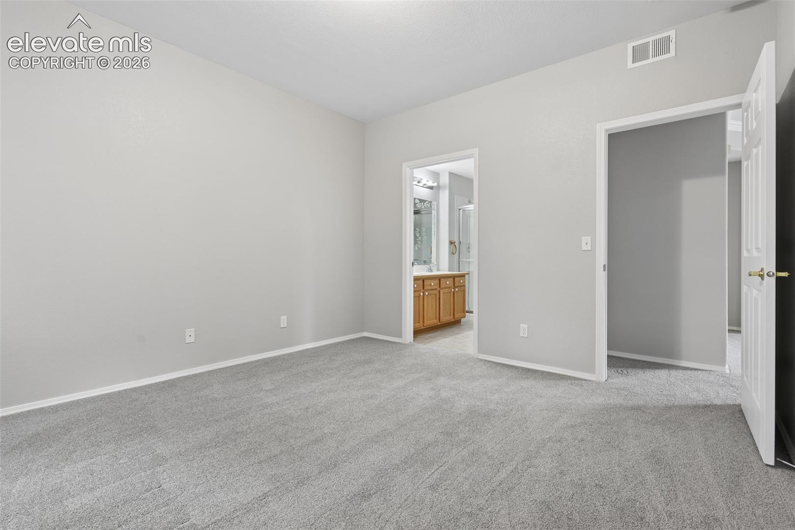Plush grey carpeting and light-toned wall finishes