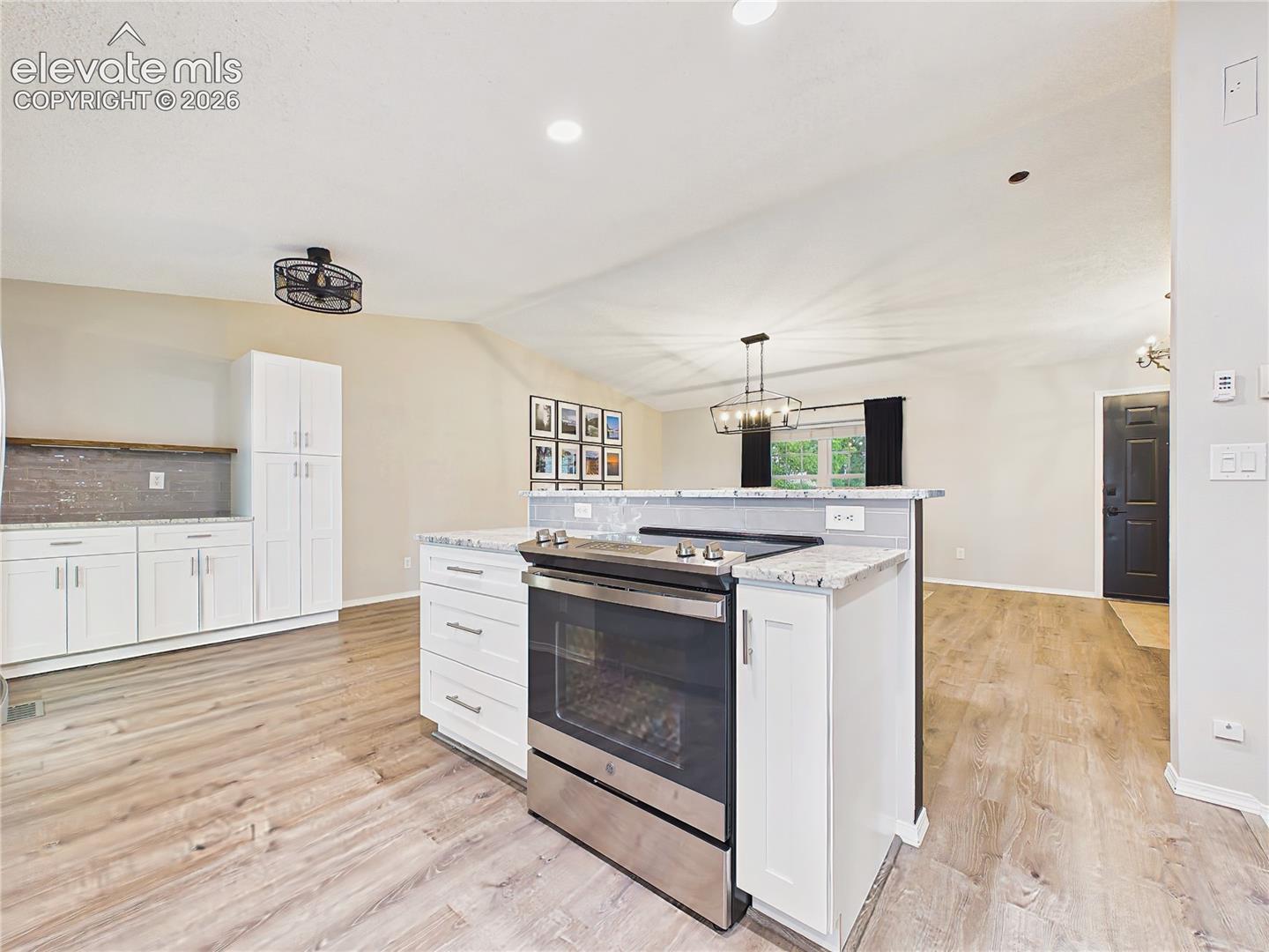 Spacious center island with bar seating, additional prep space, and an open design that seamlessly connects to the dining and living areas.