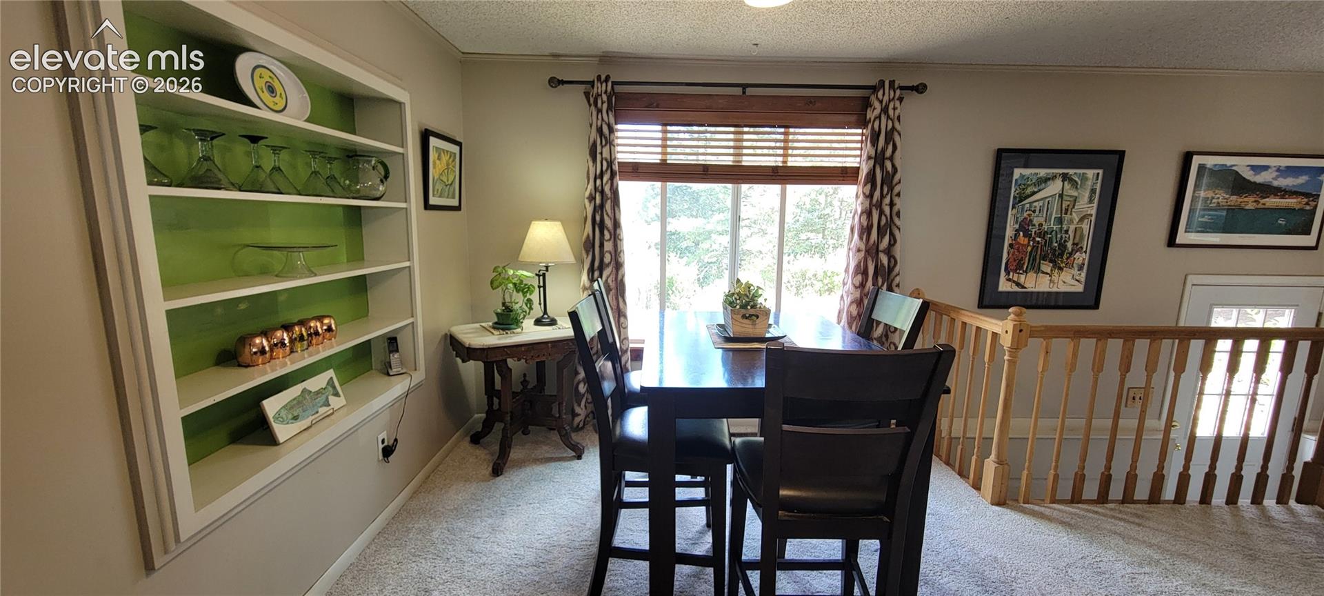 Built-in shelving with accent backing, neutral wall color, and window with wood blinds