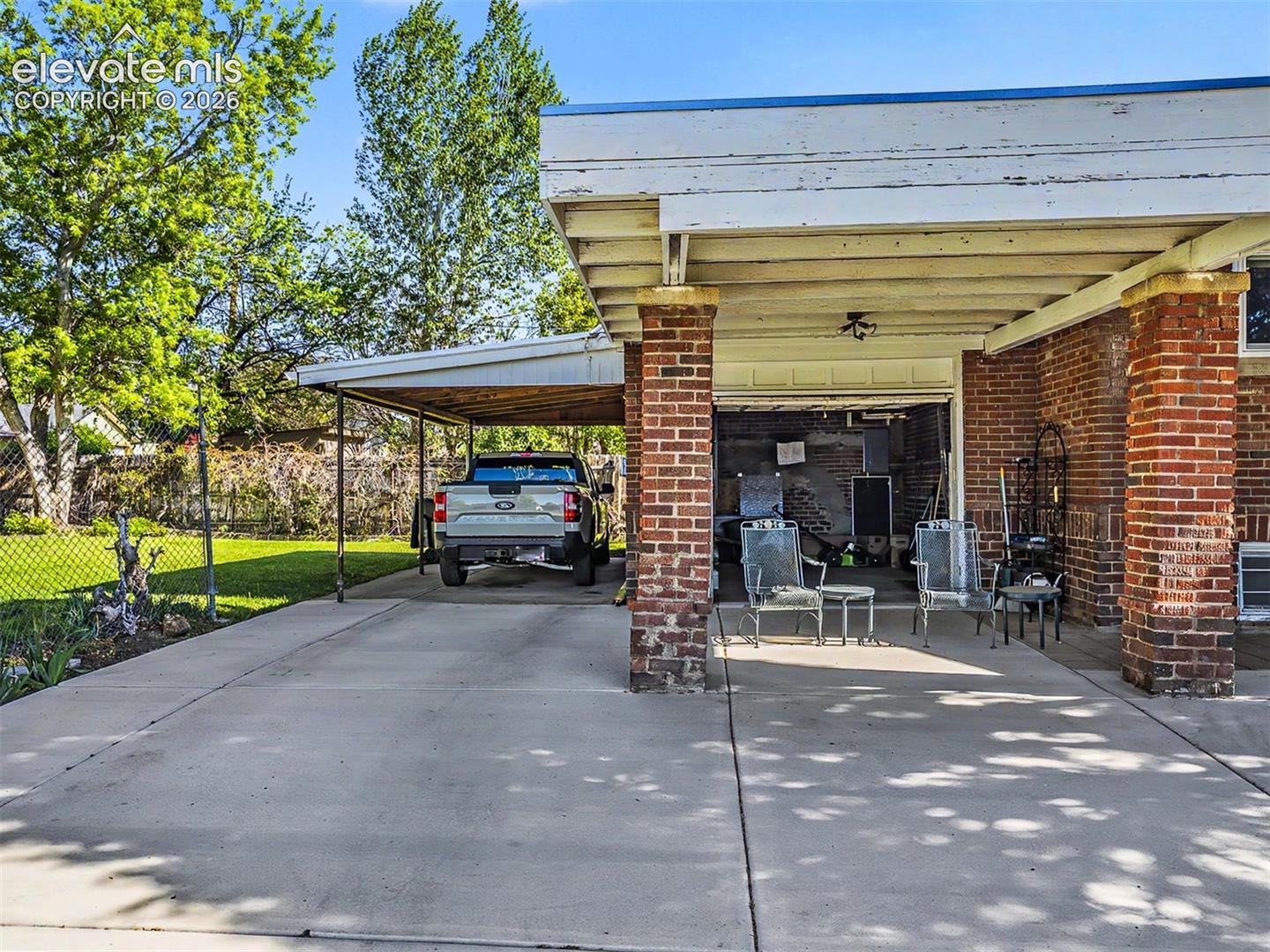 Driveway runs to attached garage and carport