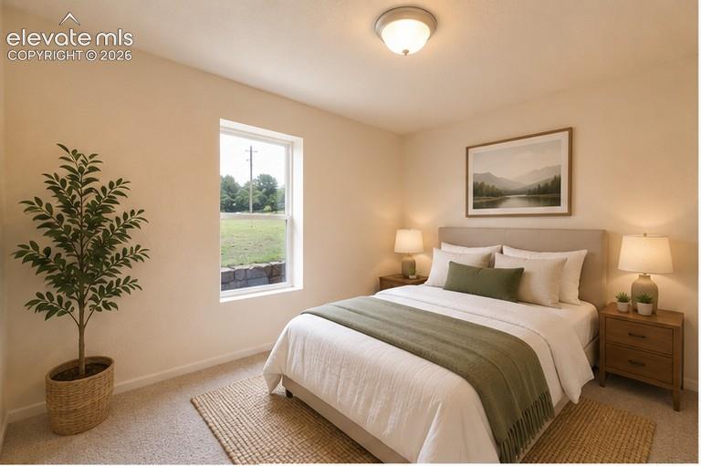 Neutral-toned room with wall-to-wall carpeting, textured wall finish, and a centered window