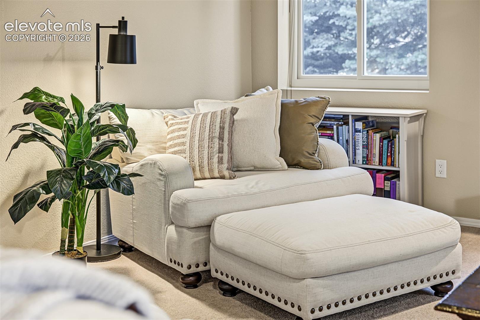 Cozy sitting and reading nook near the gas-log fireplace in the spacious walkout basement, just steps from a private bedroom suite featuring its own full bathroom with shower and a laundry room.
