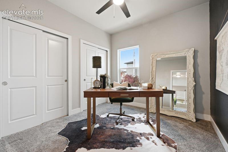 Sliding closet doors, ceiling fan, and carpeted flooring