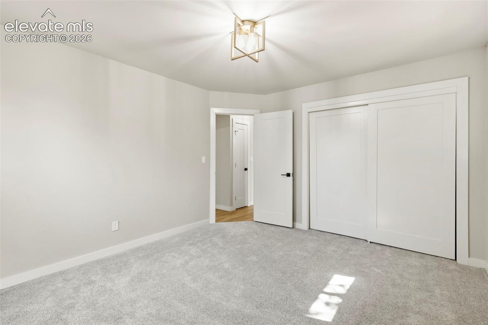 Light gray carpeting underfoot with white baseboards