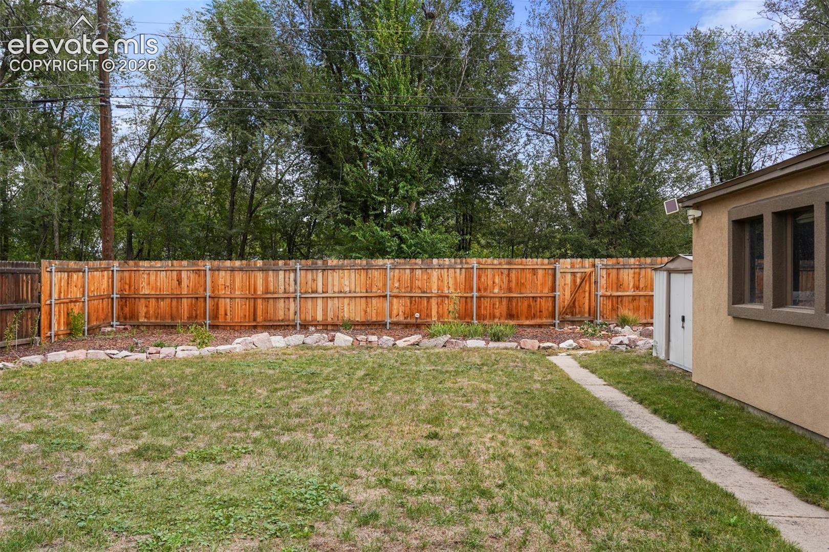 Back yard with newer rear fence
