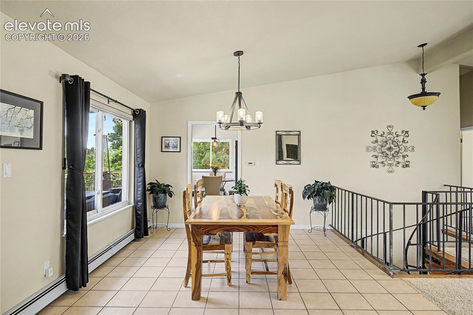 The dining area's tile flooring and open sightlines connect effortlessly to the kitchen and entry, making this an ideal layout for entertaining.