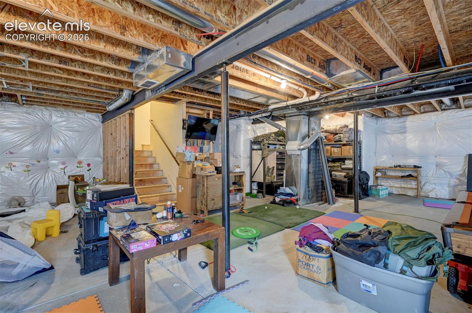 Unfinished basement with egress windows and plumbing rough-in