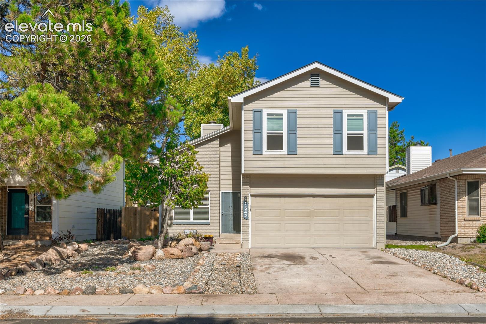 Welcome to this updated 3-bedroom, 2-bathroom home in an established Colorado Springs neighborhood! With 1,405 square feet of living space, this two-story home offers a comfortable layout with plenty of natural light throughout. As you enter, you're greeted by vaulted ceilings that make the main living area feel bright and open. The living room features an electric fireplace, adding a cozy touch to the space. Just off the living area, the kitchen offers granite countertops, updated cabinetry, and stainless steel appliances. Upstairs, you'll find all three bedrooms, providing a nice separation between the main living and sleeping areas. The fenced backyard offers plenty of room for outdoor activities, gardening, or simply enjoying Colorado's beautiful weather. An attached two-car garage and a detached oversized shed add extra convenience and storage. Located just minutes from shopping, restaurants, parks, and other everyday amenities, this home offers easy access to everything Colorado Springs has to offer. Schedule your showing and come see it for yourself!