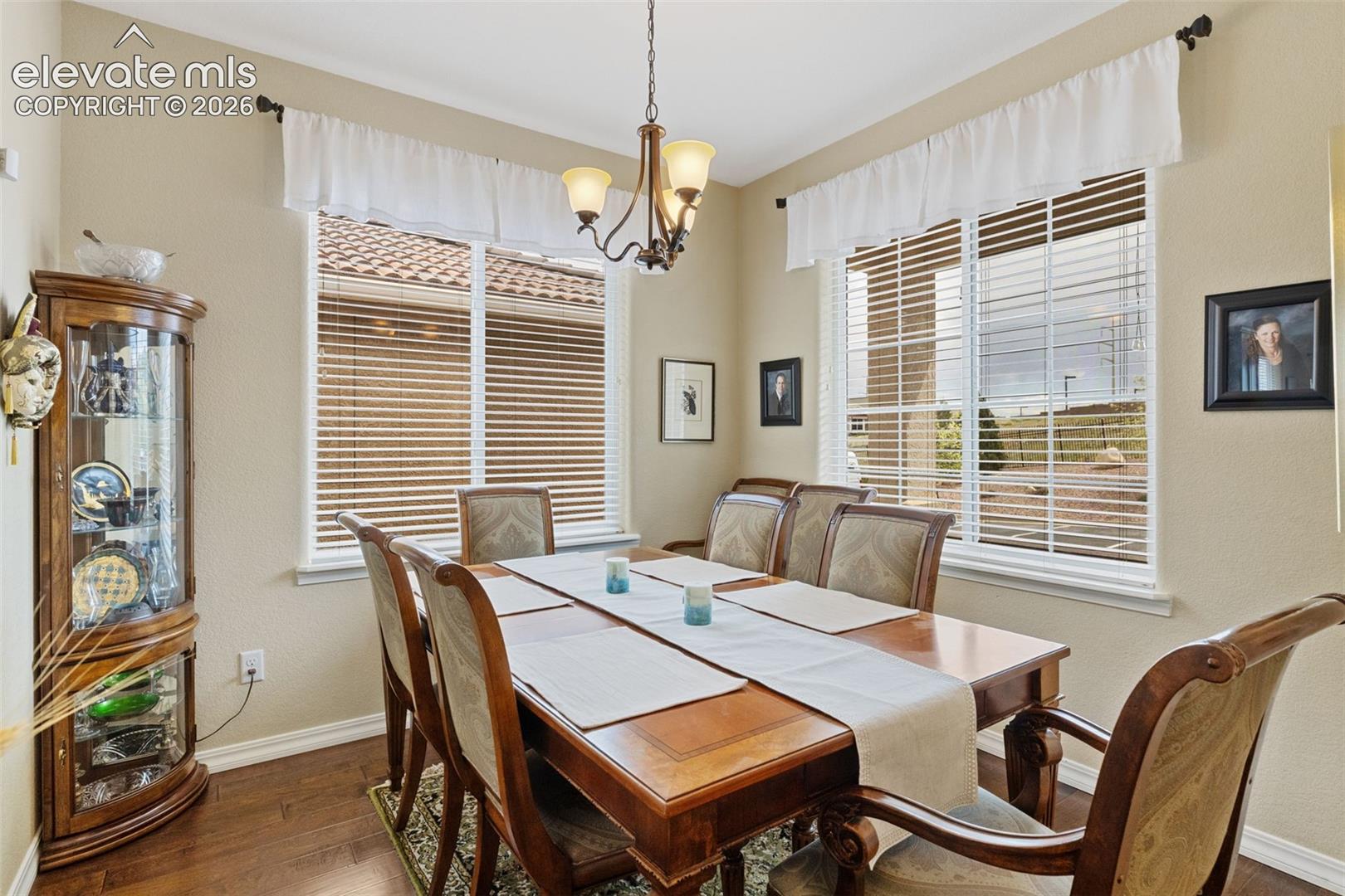 Formal dining area featuring wood-finish flooring.