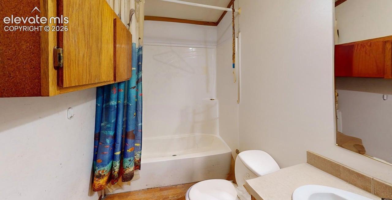 Bathroom with vanity and shower / bath combination with curtain