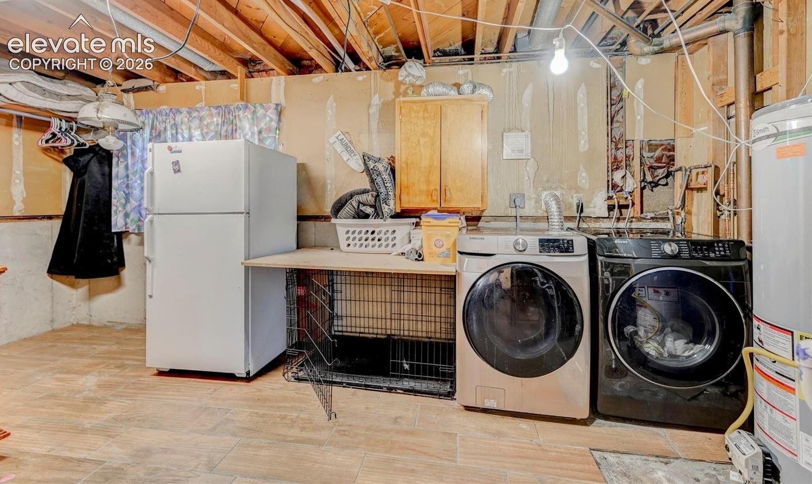 Utility space featuring wood-finish tile flooring, wall-mounted wood cabinetry, and a dedicated plumbing connection for laundry appliances