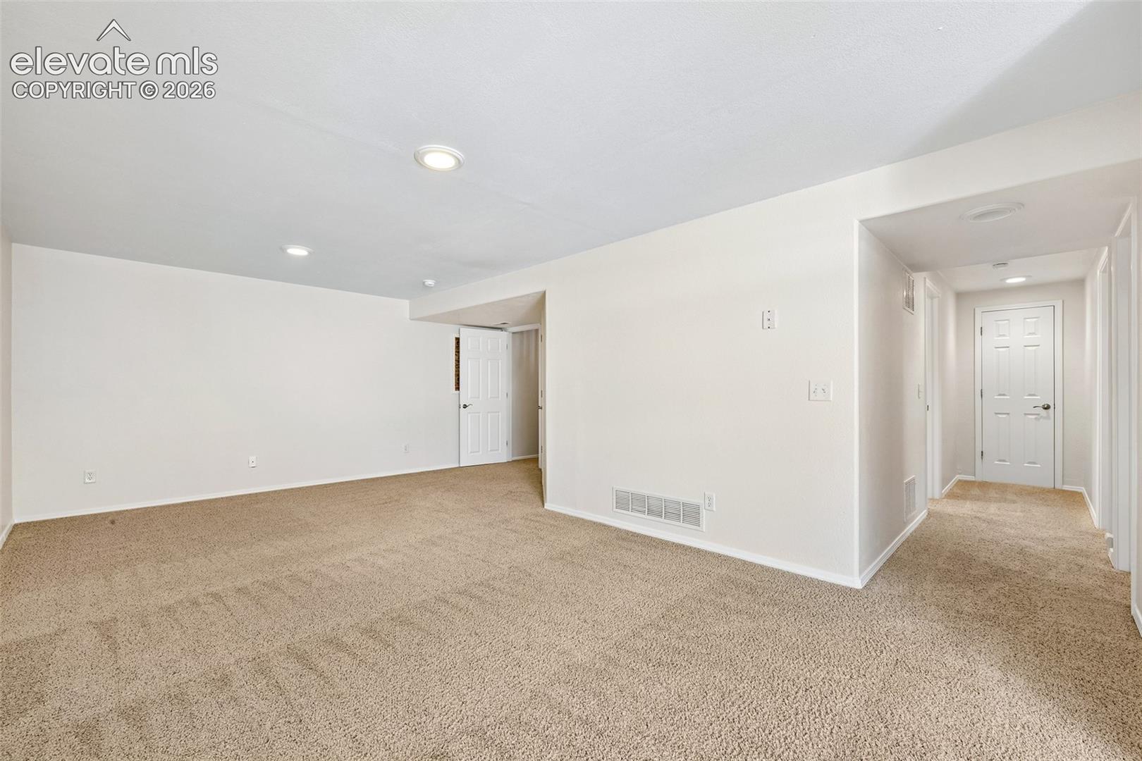 Basement Family Room , Recessed ceiling lighting, neutral tone carpet flooring, white paneled interior doors