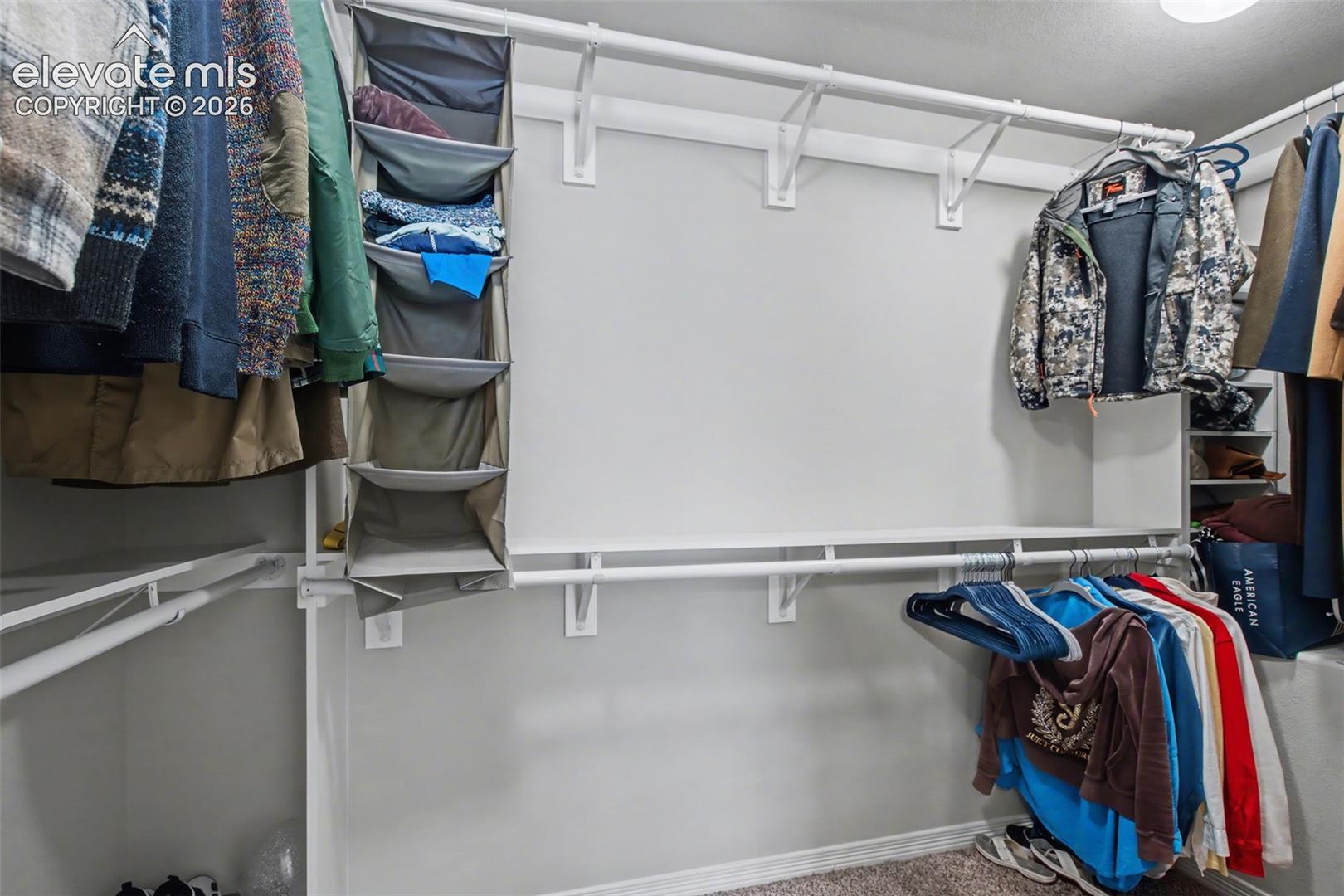 Customizable closet system featuring multiple hanging rods and shelving