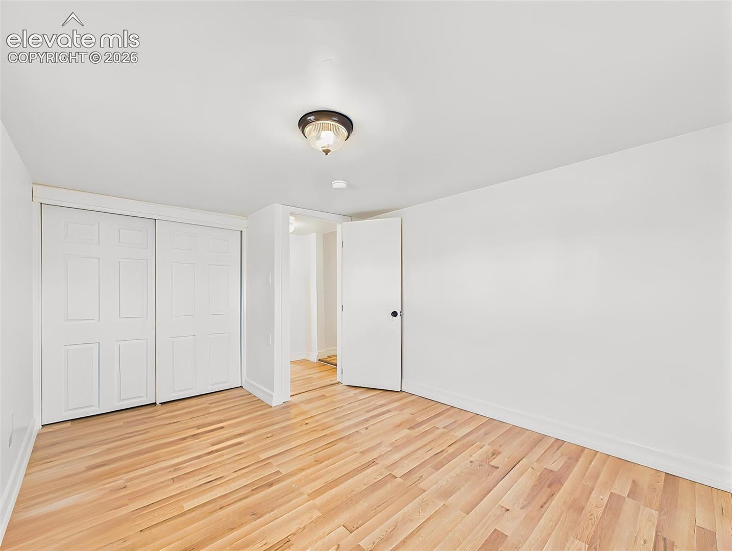 Secondary Bedroom – Spacious secondary bedroom offers a large closet, new flooring, and abundant natural light.