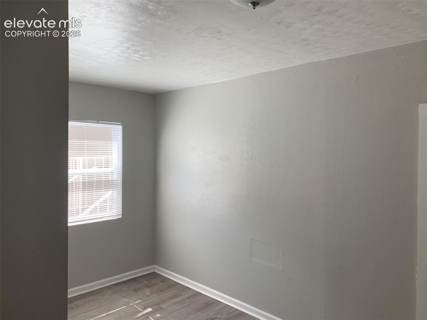 Wood-finish flooring with crisp white baseboards