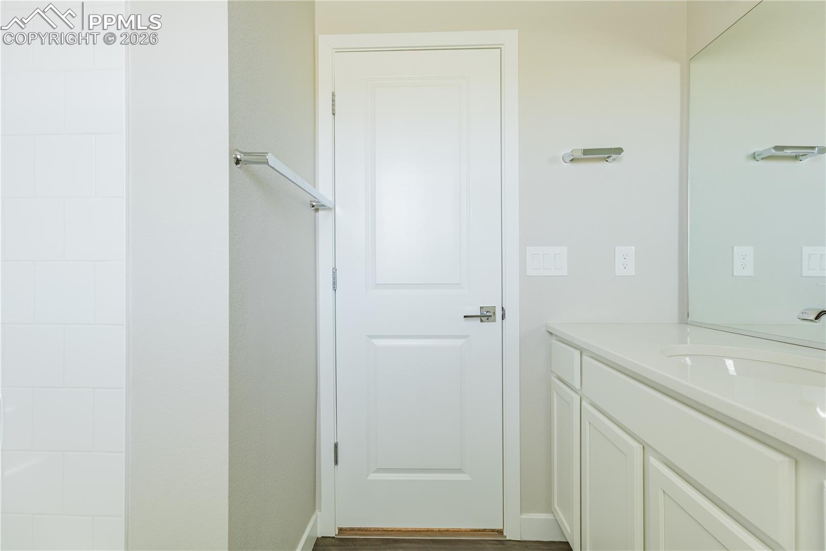 Bathroom with vanity and dark wood-style flooring