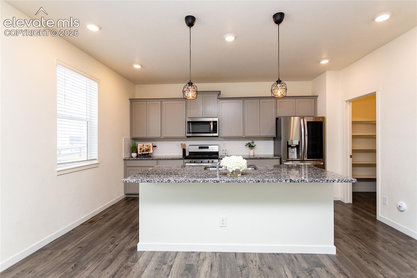 Kitchen is highlighted by the large island offering countertop seating.