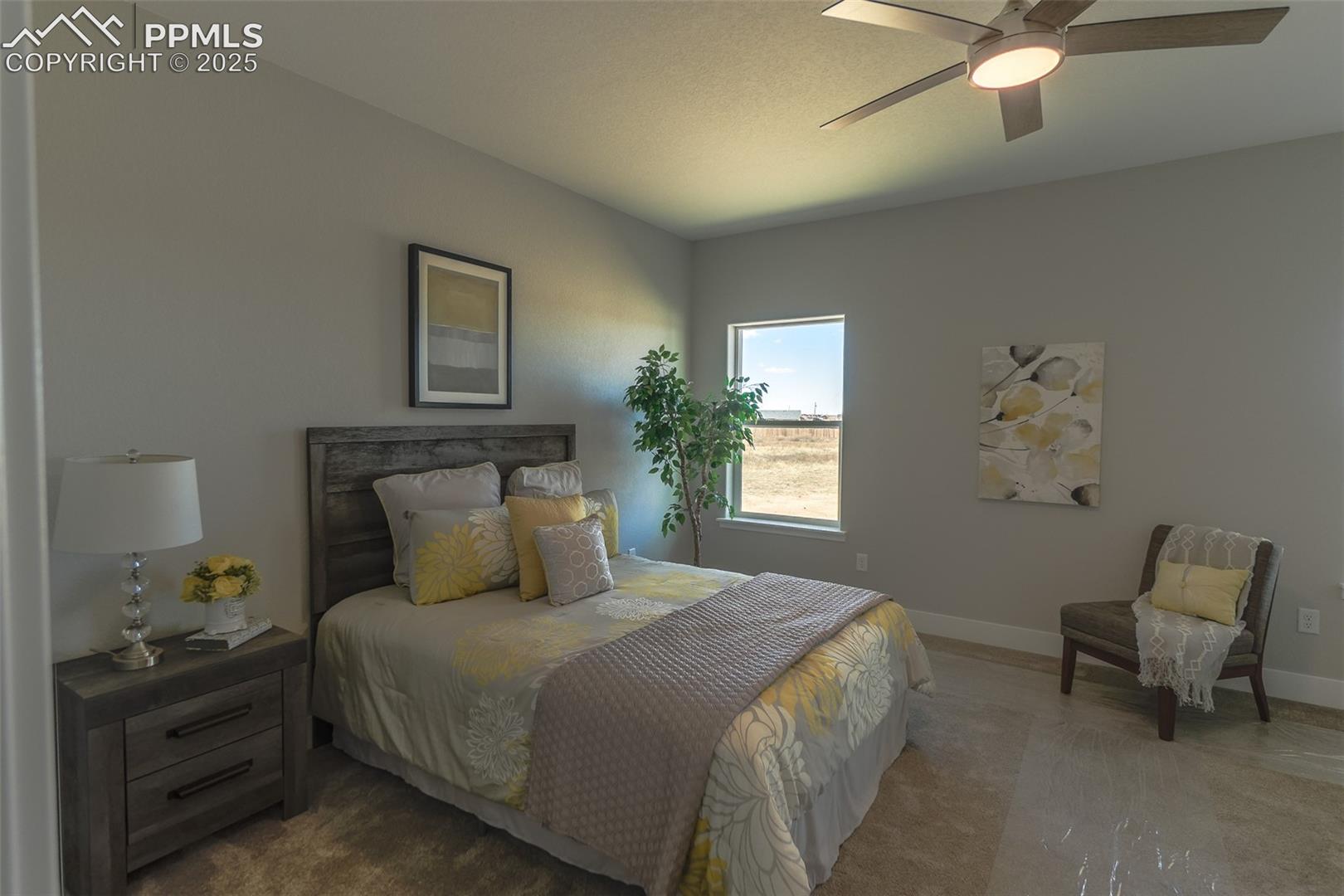 Carpeted bedroom with ceiling fan