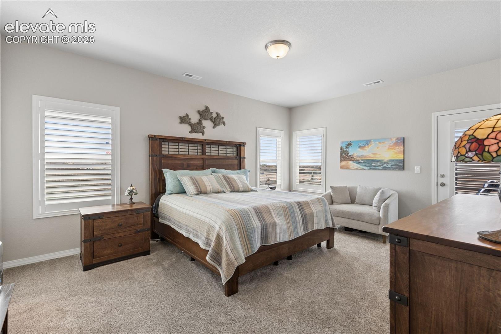 Spacious primary suite has space for all of your furniture and a sitting area.