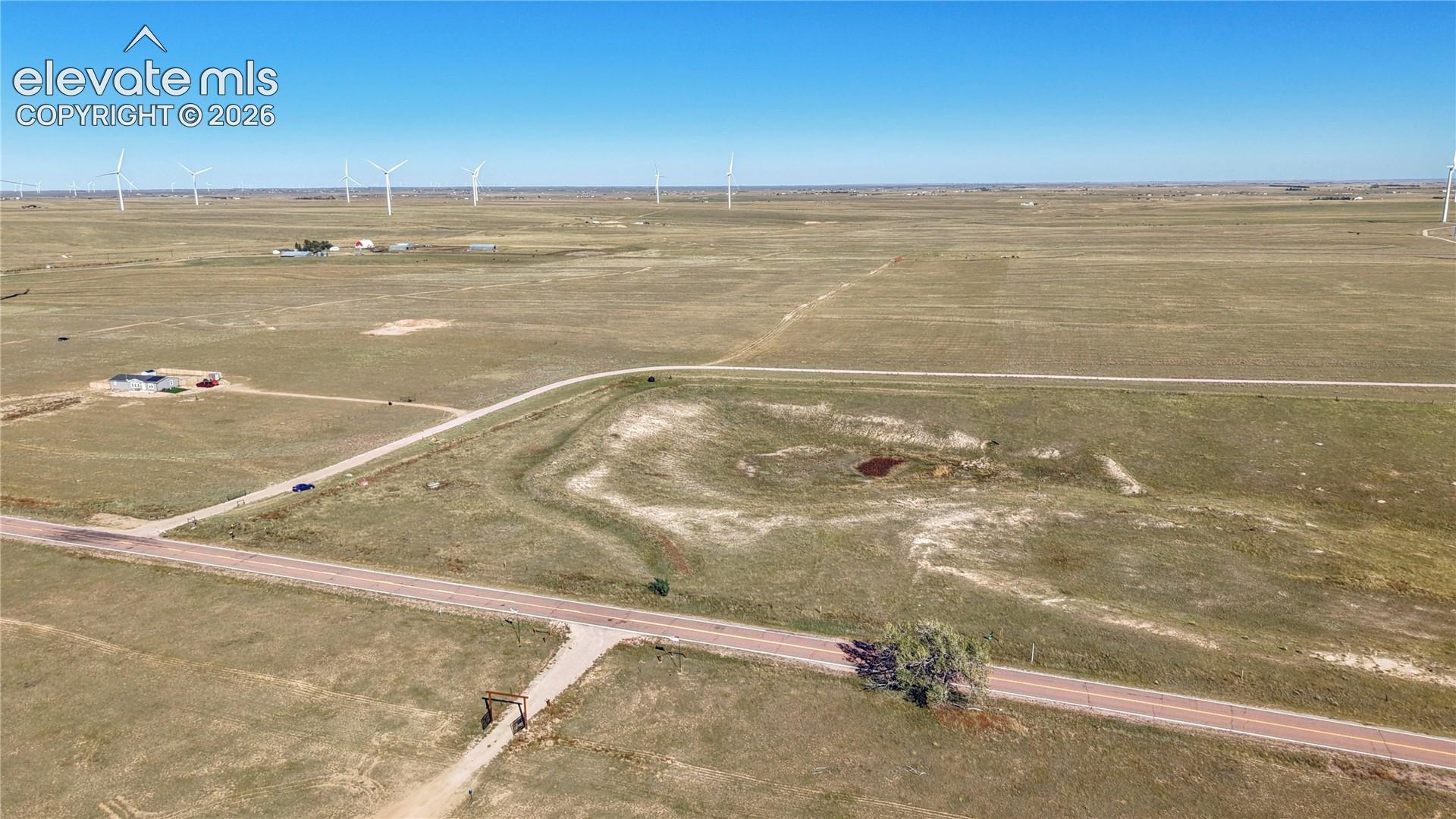 Expansive acreage featuring flat topography, direct road access, and a natural surface depression