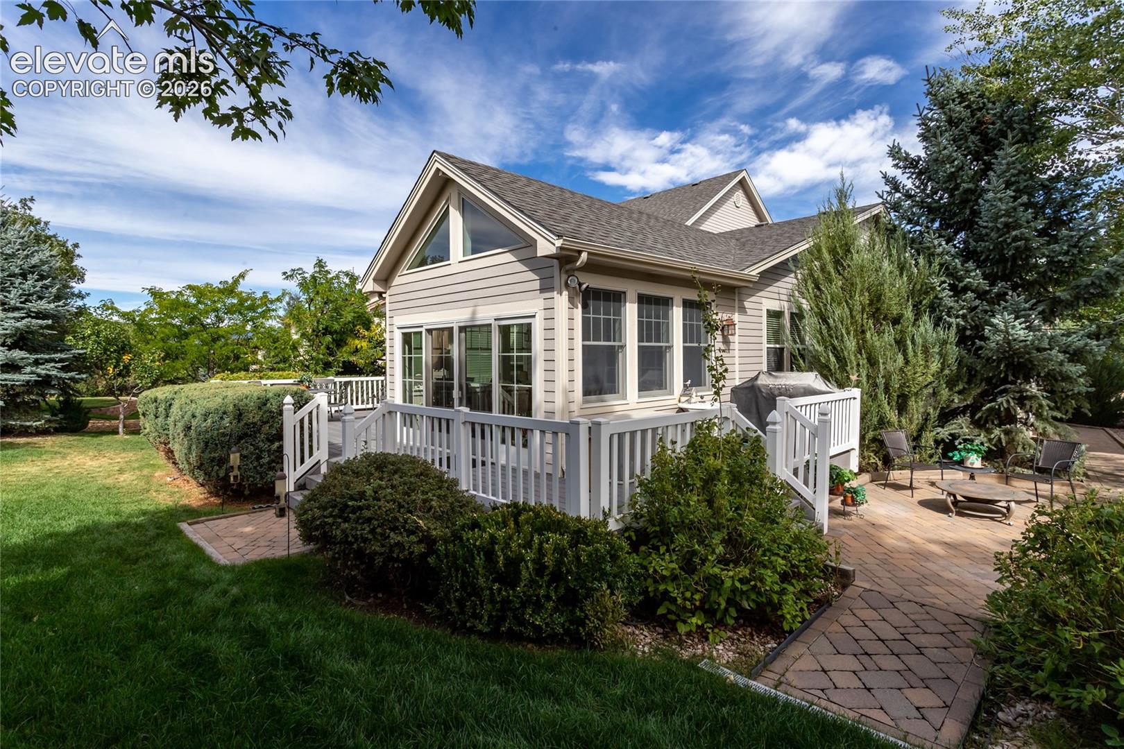 Composite deck wraps around the sun room and steps down to the brick paved patiospace!