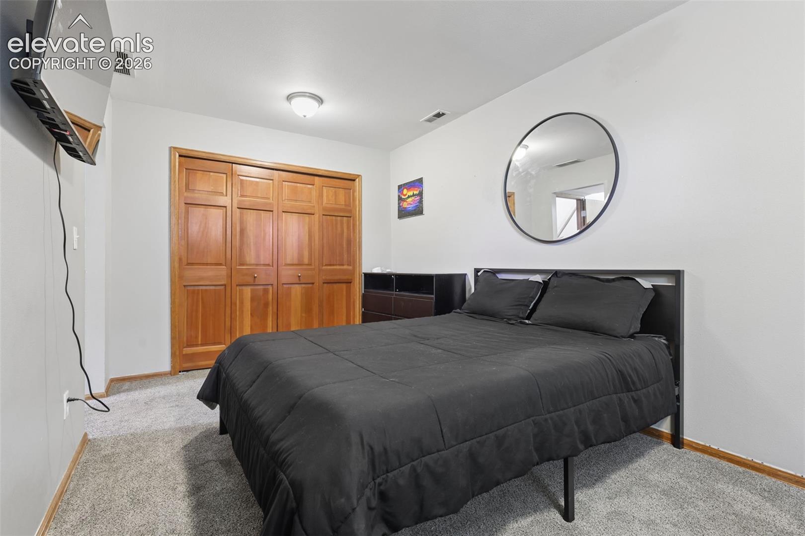 Carpeted flooring, wood-finish closet doors, and recessed lighting