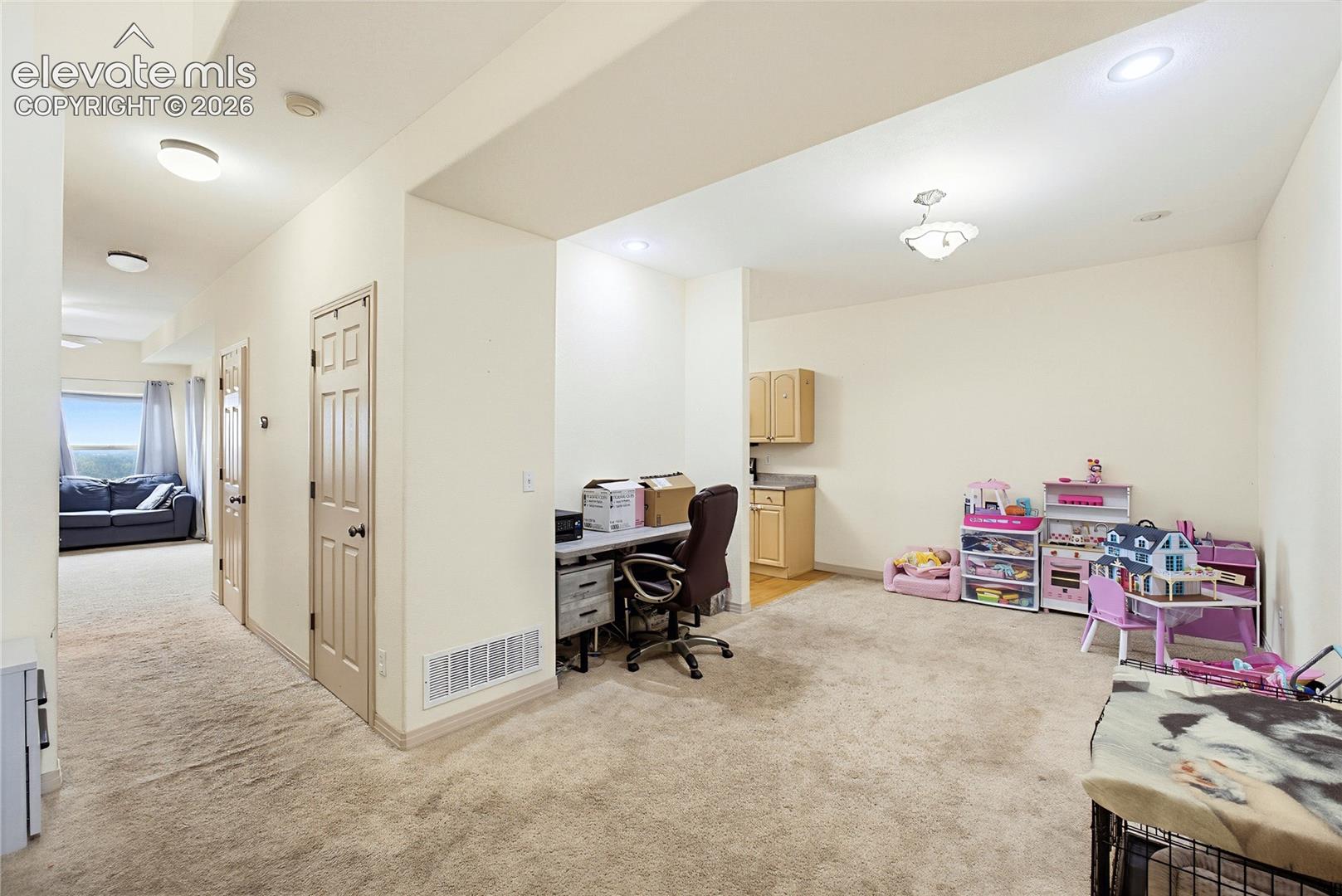 Recessed ceiling lighting, built-in cabinetry with laminate countertops, and neutral-toned wall paint