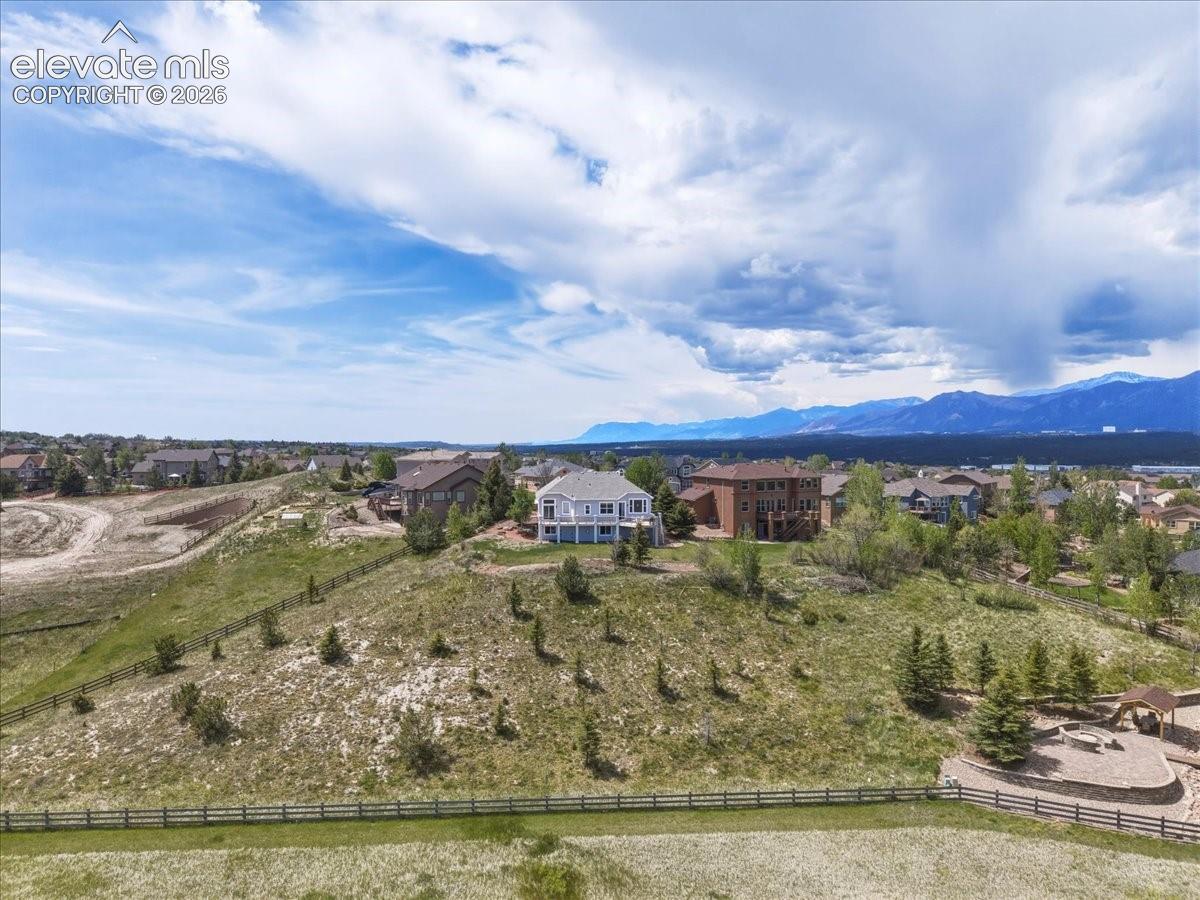 Impressive rear elevation showcasing multiple outdoor living spaces, elevated decks, and a spacious backyard.