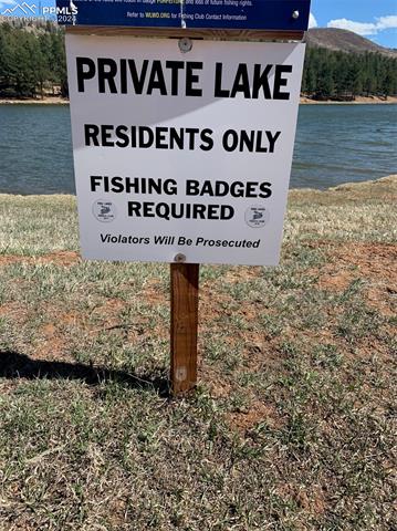 Community / neighborhood sign with a water view