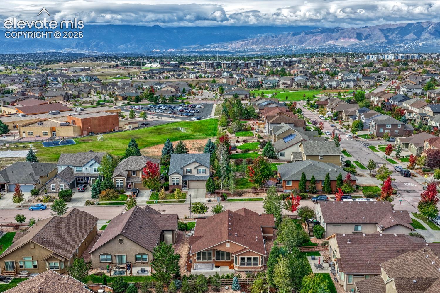 Aerial view of the rear of the home and neighborhood including Ranch Creek Elementary School.