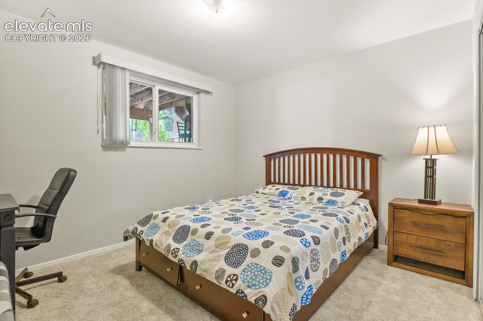 Light gray walls with a window featuring horizontal blinds