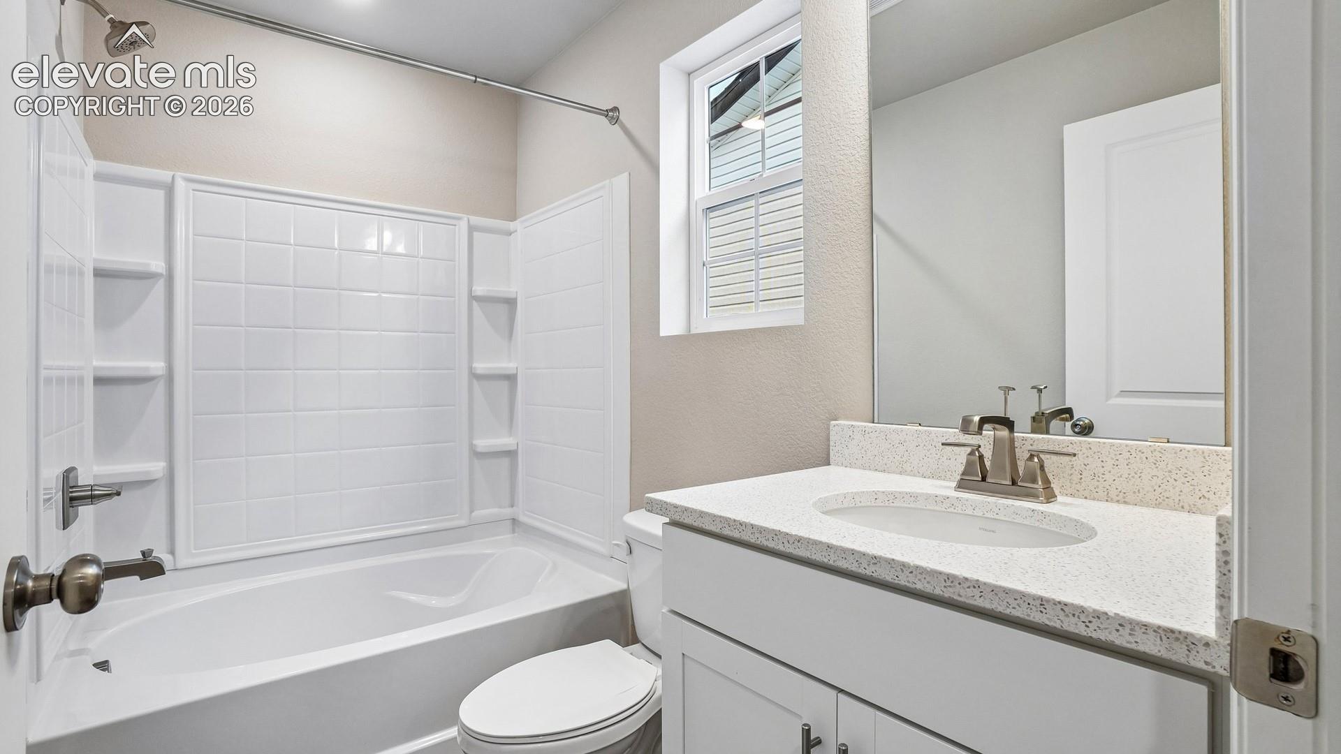 White vanity with a stone-finish countertop, undermount sink, and brushed nickel faucet
*photos of a model home*